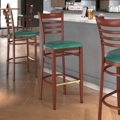 Cheapest ❤️ LT&S Spartan Series Lancaster Table & Seating Spartan Series Bar Height Metal Ladder Back Chair With Mahogany Wood Grain Finish And Green Vinyl Seat ✔️